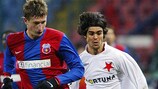 Steaua's Dorin Goian (left) vies for the ball with Slavia's Gaucho