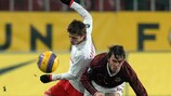 Karol Kisel and Torbinskiy struggle to gain possession