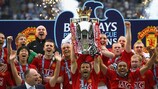Ryan Giggs lifts the Premier League trophy yesterday - but red will soon give way to light blue and white in their home city