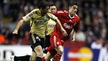 Liverpool's Albert Riera (right) competes with Lorik Cana