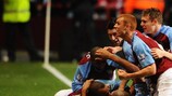 Zat Knight is buried beneath claret and blue shirts after earning a late point against Arsenal last month