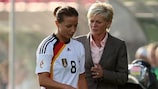 Silvia Neid looks on anxiously as Inka Grings leaves the field with a knee problem