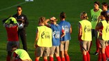 Hope Powell (left) speaks to her England players in Tampere