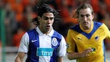 Goalscorer Falcao is challenged by Joost Broerse during Porto's away win against APOEL in November 2009