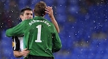 Aaron Hughes and Mark Schwarzer embrace as the snow falls in Basel