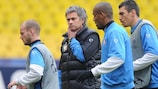 José Mourinho looks on as Wesley Sneijder (left) walks off with a training injury