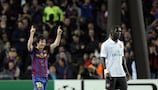 Bacary Sagna stands dejected as Lionel Messi celebrates