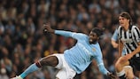 Paulo De Ceglie looks on as City's Emmanuel Adebayor stretches for the ball