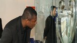 Marcel Desailly takes a close look at the UEFA Champions League Trophy he lifted twice as a player