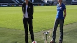 Annie Saladin (left) and Nadine Bieneck pose with the UEFA Women's Champions League match ball and trophy at Craven Cottage
