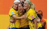 Sweden's Lotta Schelin is mobbed by her team-mates after scoring against France