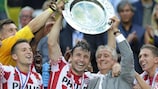 Mark van Bommel receives the trophy from former PSV player Willy van der Kuylen