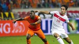 Jetro Willems (left) strides away from Turkey midfielder Arda Turan