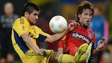 Metalist's Edmar (left) vies for possession with Hajime Hosogai in their draw with Leverkusen