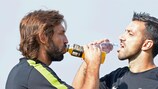 Juventus's Andrea Pirlo and Fabio Quagliarella stop for a drink during training