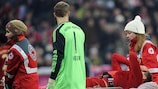 Holger Badstuber is carried from the pitch as Manuel Neuer looks on