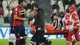 Nicklas Bendtner is carried off against Cagliari