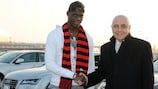 Mario Balotelli is greeted at Malpensa Airport by Milan vice-president Adriano Galliani