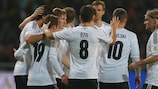 Thomas Müller is congratulated after scoring the third goal for Germany