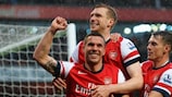 Lukas Podolski, Aaron Ramsey and Per Mertesacker celebrate a goal in north London tonight