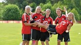 Pernille Harder, Mariann Knudsen, Johanna Rasmussen and Katrine Veje lift Line Røddik Hansen