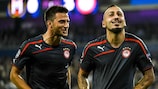 Kostas Mitroglou (right) celebrates scoring his third goal for Olympiacos