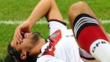 Sami Khedira lies injured during Germany's 1-1 friendly draw in Italy