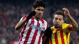 Atlético's Diego Costa and Jordi Alba of Barcelona tussle for possession in the Spanish capital