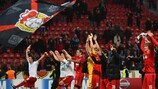Leverkusen players applaud the crowd at the final whistle