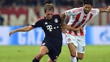 Bayern full-back Philipp Lahm (left) tussles with Olympiacos' Alejandro Domínguez
