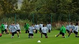 Celtic players stretch their legs in preparation for their home game against Man. City