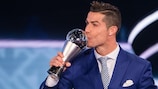 Cristiano Ronaldo kisses his Best Men's Player trophy