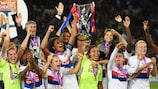 Wendie Renard and Sarah Bouhaddi lift the trophy after Lyon's shoot-out success