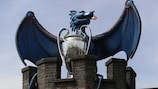 A dragon and the UEFA Champions League trophy on the walls of Cardiff Castle