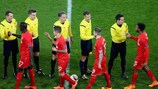 Liverpool players shake hands with match officials