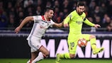 Lyon's Léo Dubois (left) tries to hold Lionel Messi in check during the first leg