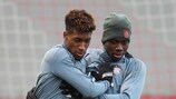 Kingsley Coman and Alphonso Davies keeping warm in training