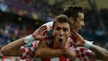 Mario Mandžukić celebrates with Croatia captain Darijo Srna after scoring against Italy