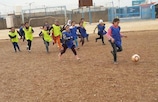 The Spirit of Soccer - girls chasing a football in Iraq