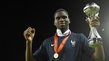 Odsonne Edouard, medal around his neck, with the UEFA European Under-17 Championship trophy