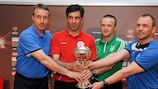 The Group A coaches pose with the UEFA European Under-17 Championship trophy