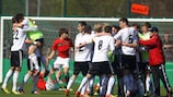 Germany celebrate qualification for the finals after a draw with Portugal