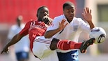 Danny Amankwaa (left) challenges England's Raheem Sterling