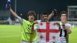 (L-R) Georgia's Davit Jikia, Giorgi Papunashvili, and Dato Dartsimelia celebrate beating Iceland