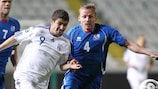 Cyprus's Dimitris Christofi (left) goes shoulder to shoulder with Kristján Sigurdsson