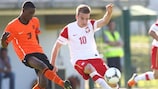 Poland midfielder Adrian Cierpka is shadowed by Netherlands defender Riechedly Bazoer