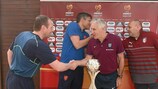 The coaches in Group D shake hands at the tournament hotel in Pomorie