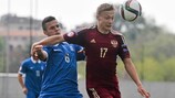 Russia's Mikhail Lysov fends off the challenge of Greece midfielder Spyros Natsos