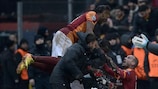 Didier Drogba leaps onto goalscorer Wesley Sneijder in celebration