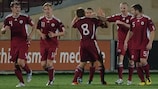Latvia players celebrate the only goal